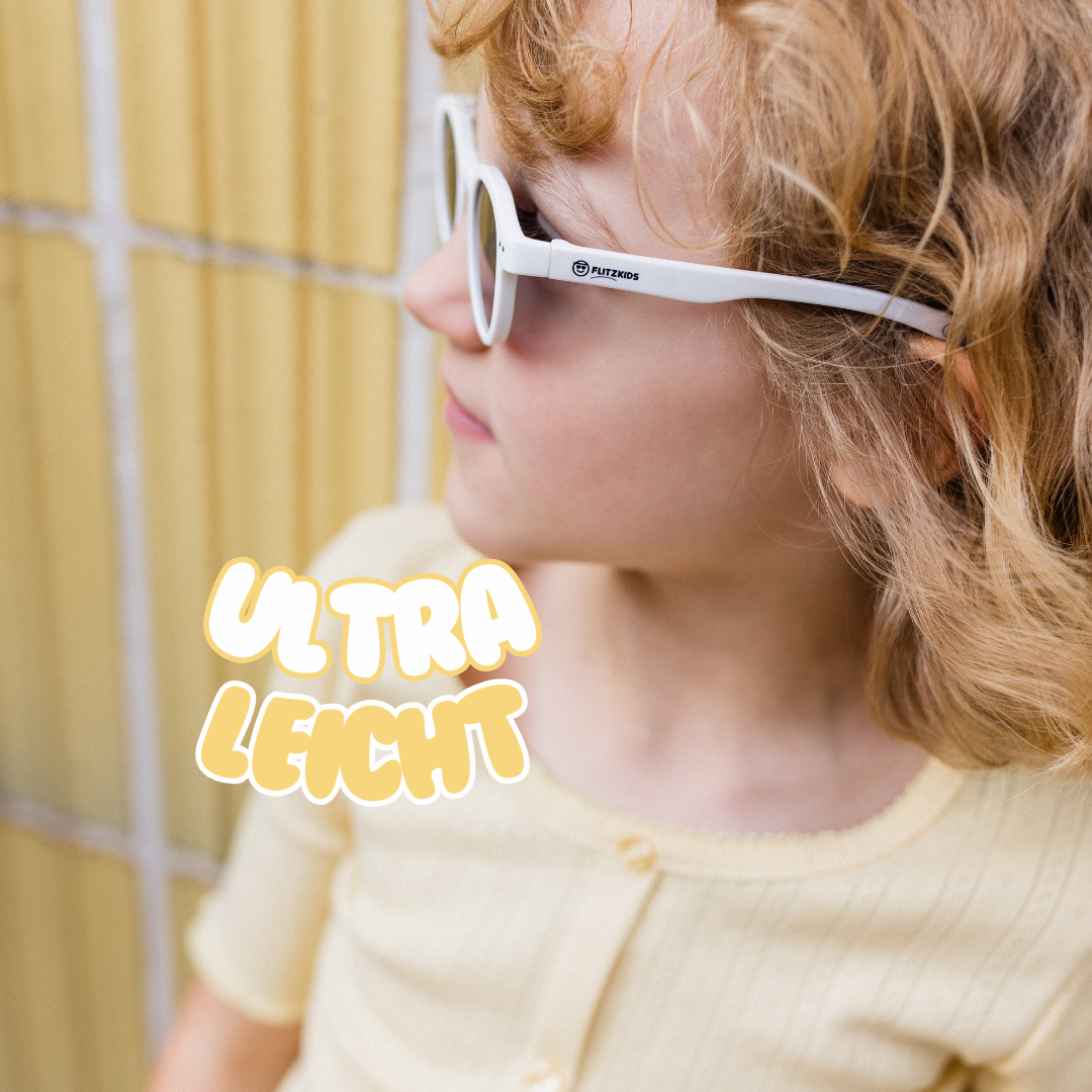 Mädchen im Alter von 6 Jahren trägt weiße trendige flitzkids kindersonnenbrille