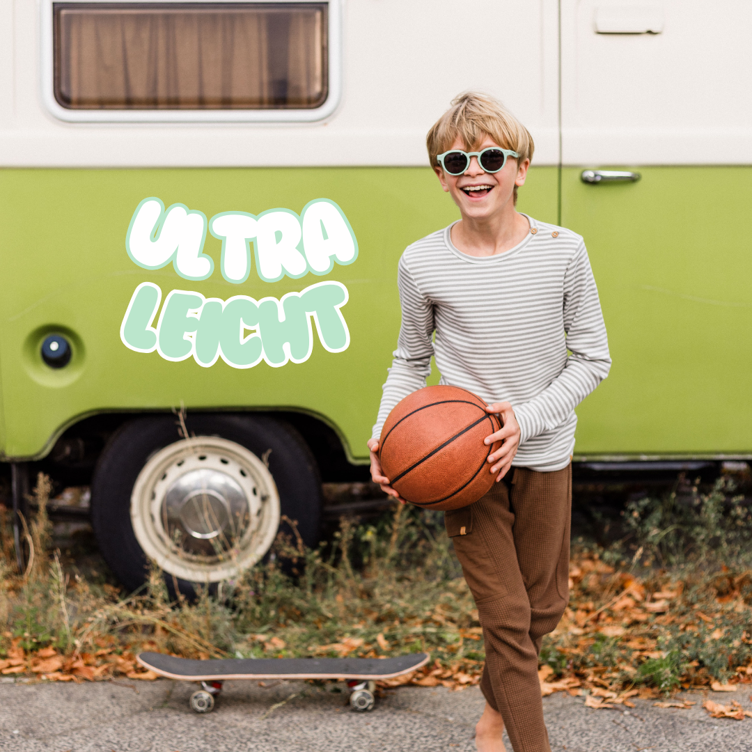 Junge spielt draußen mit Kindersonnenbrille